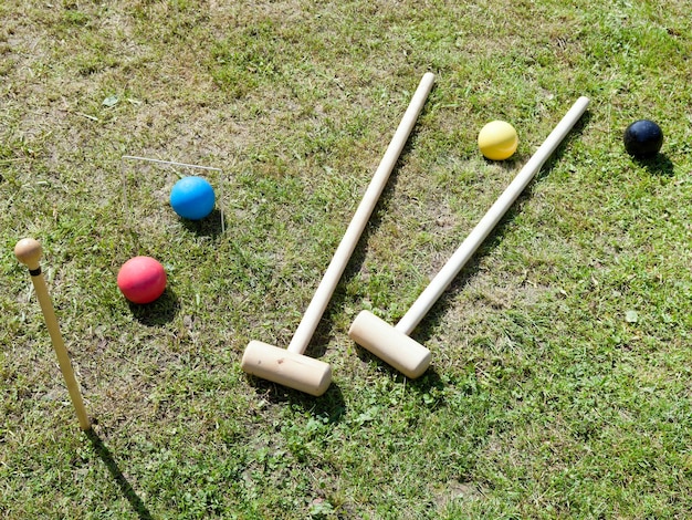 Game of croquet on green lawn