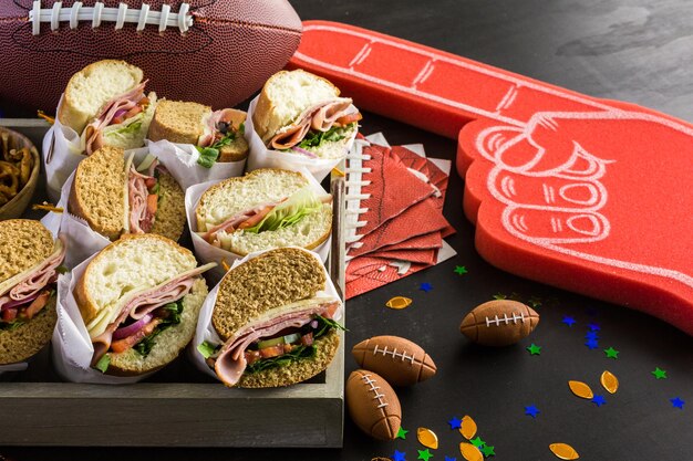 Game day football party table with  sub sandwich and snacks.