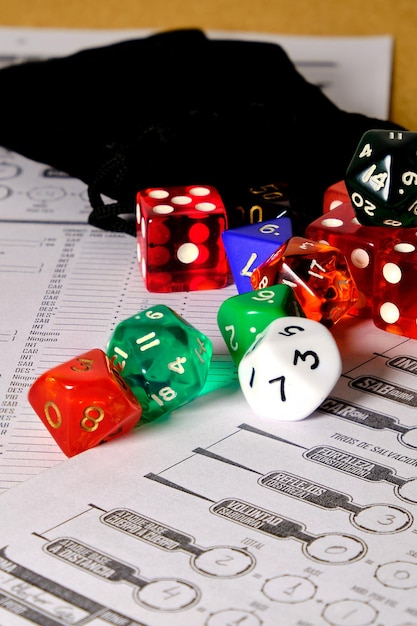 Photo game of dice to play role-playing of different colors on a table.