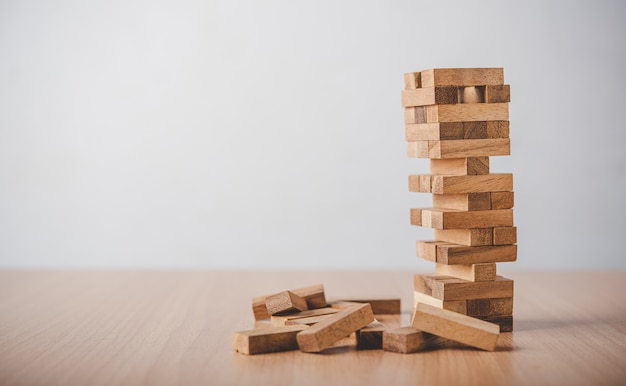 Game drew to a wooden block from the tower.concept  business risks in the business. Requires planning meditation must be careful in deciding to reduce the risk in the business.