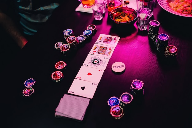 Game poker table with chips and cards on the excitement and success