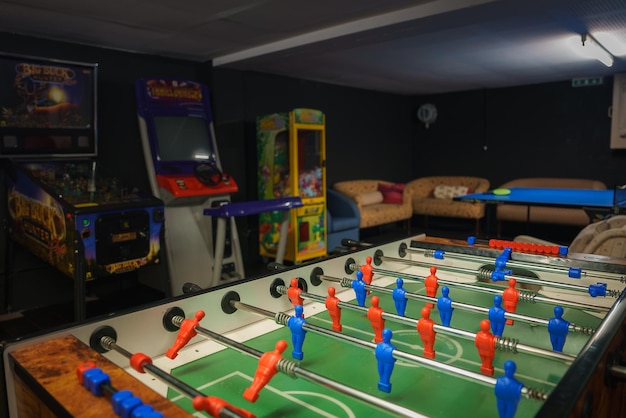 Photo game room with foosball table arcade machines and couch