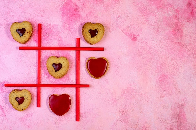 Game of TIC TAC toe cookies in the shape of a heart. Concept of Valentine's Day