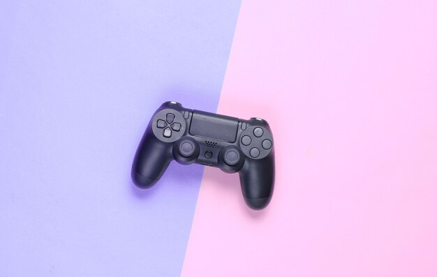 Gamepads on a colored paper background