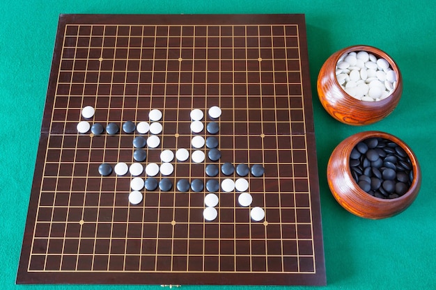 Gameplay of Go game and playing stones in bowls