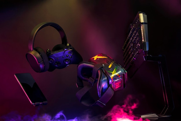 Gamer devices for playing game by joystick with computer\
headphone and mouse on neon glow, gaming and esports challenge,\
streaming online, tournament concept