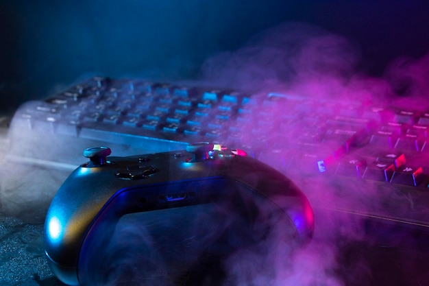 Gamer devices for playing game by joystick with computer\
headphone and mouse on neon glow, gaming and esports challenge,\
streaming online, tournament concept