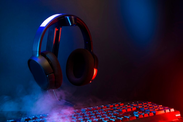 Gamer devices for playing game by joystick with computer\
headphone and mouse on neon glow, gaming and esports challenge,\
streaming online, tournament concept