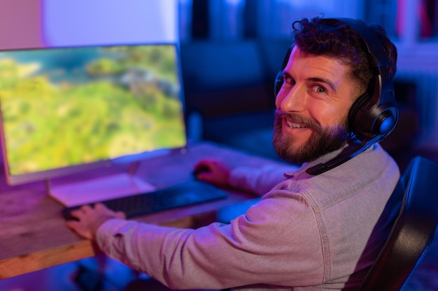 Photo gamer enjoying vivid game graphics in neon light