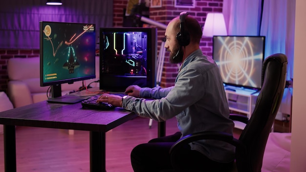 Gamer playing fast paced space shooter simulation screaming\
victorious at the computer screen after winning difficult level.\
caucasian man celebrating victory in internet multiplayer action\
game.