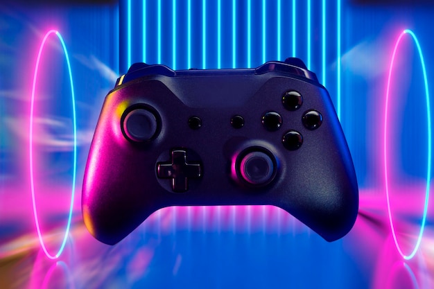 Gamer playing the online game with joystick controller in neon glow dark cyberpunk room gaming and esports challenge tournament streaming streamer with analog device in living house