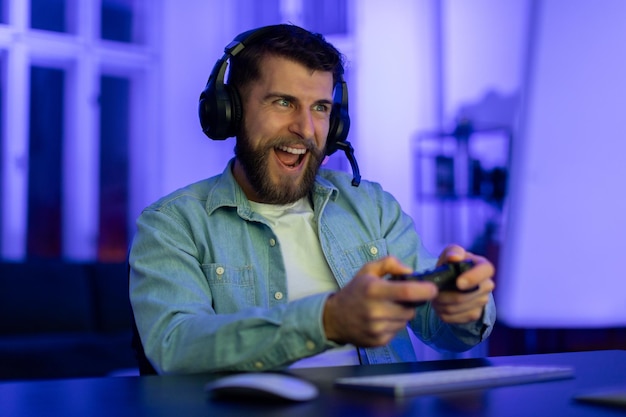 gamer playing with controller and headphones at home