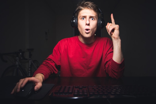 Gamer plays on the computer raise his thumb up he has an idea