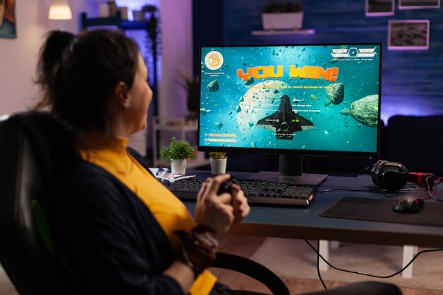 Premium Photo  Excited player winning an important virtual egame  competition of space shooter video game playing on powerful computer