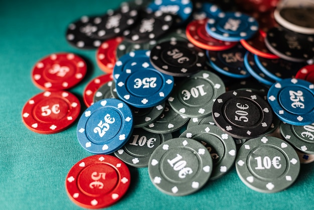 Gaming chips for gambling card games and poker on the background of a green table