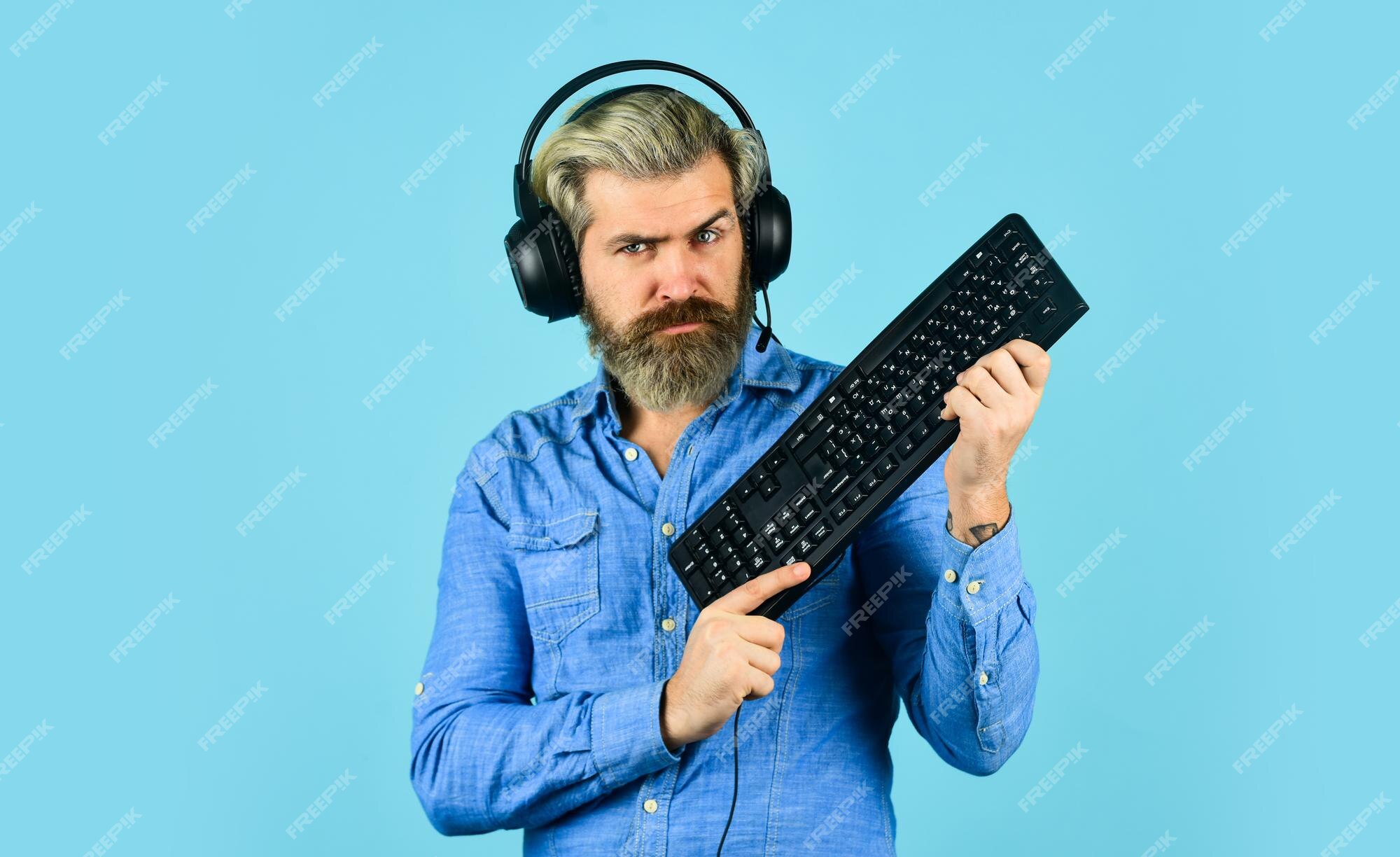 Gaming addiction. Man bearded hipster gamer headphones and keyboard. Play  computer games. Online gaming platform. Gaming modern leisure. Cyber sport  arena. Gaming PC build guide. Graphics settings Stock Photo by ©stetsik  510565044