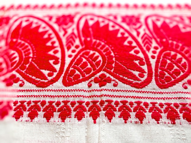 Photo gamosa or gamusa is a traditional textile pattern from assam red amp white cloth textured background