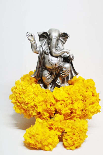 Ganesha god is the Lord of Success God of Hinduism on Marigold flowers