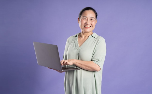 Gangang middleaged Asian female portrait posing on purple background