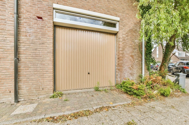 A garage door on the side of a brick building