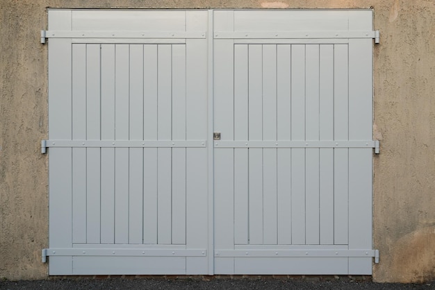 Garage double Wooden Door white on french wall city facade