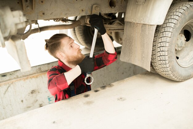 Photo garage operator repairing truck