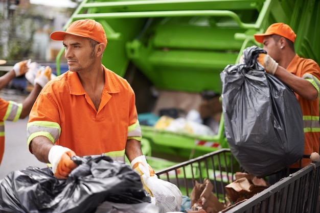 Garbage collection day Cropped shot of a garbage collection team at work