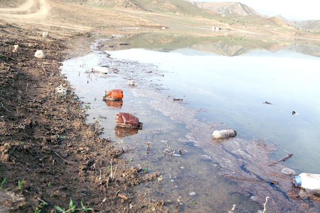 Garbage on the lake during the day