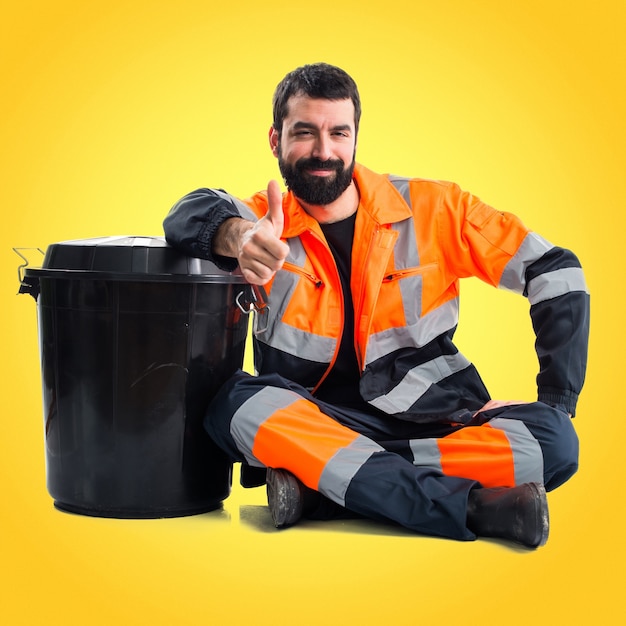 Garbage man with thumb up on colorful background