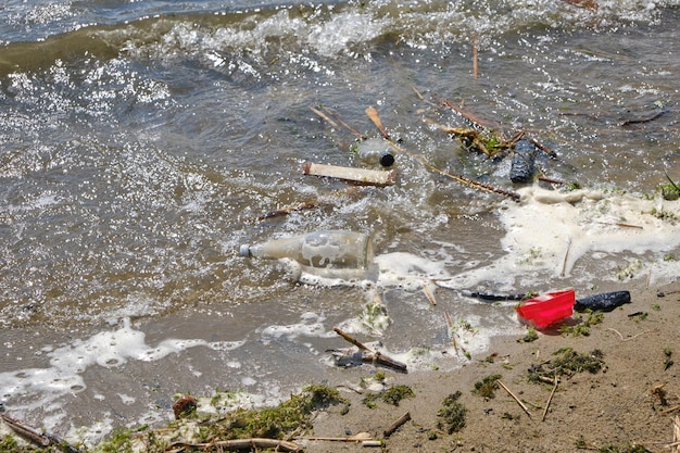 Garbage thrown out by waves beach pollution of environment of human activity