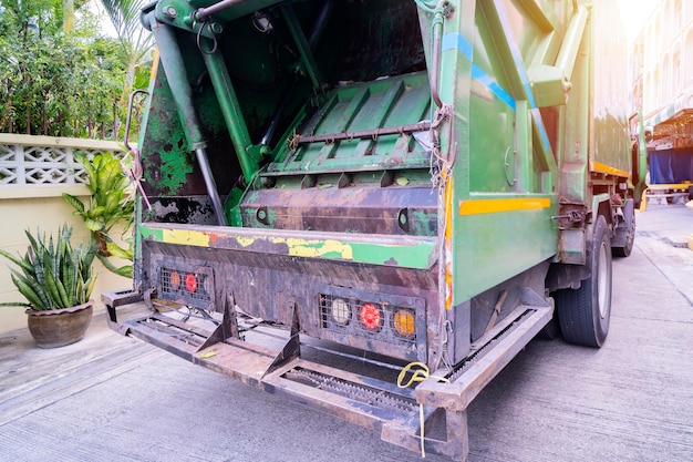 Garbage truck is carrying waste into a garbage truck travel to
collect garbage in the village