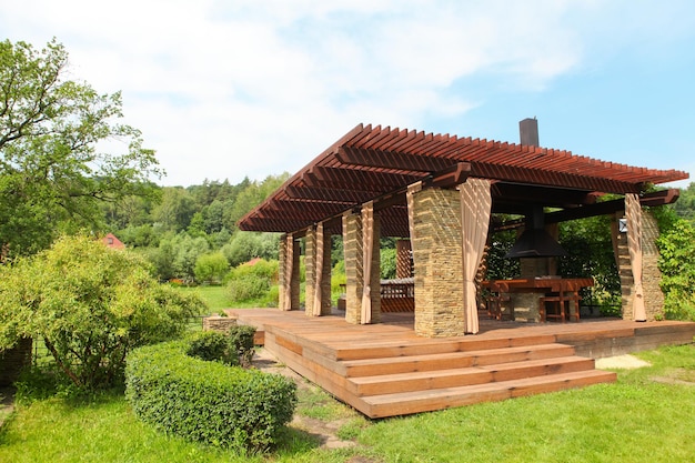 Garden brick house with wooden couch and white pillows