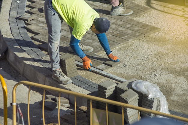 Garden brick pathway paving by professional paver worker