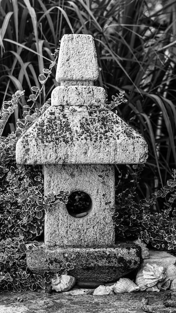 Garden decorations made of stones and stone sculptures among nice greens