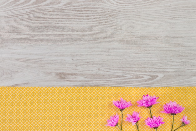 Garden flowers composition on wooden table with copy space