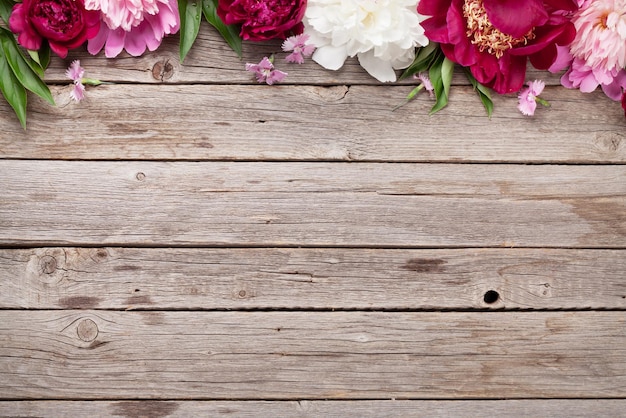 Garden peony flowers on wood