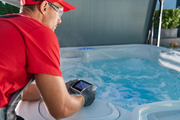 Garden spa technician testing hot tub remote