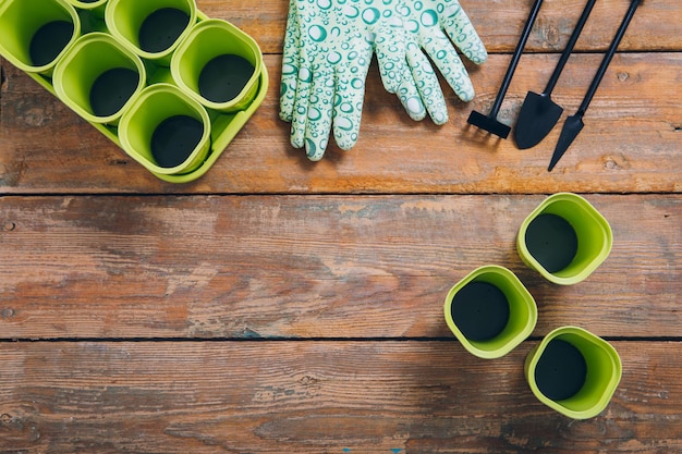 Garden tool for seedlings on brown wooden background. Preparation for the planting season. Selective focus.