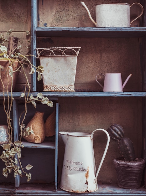 Garden tools and flowerpots on wood shelf background with vintage feel