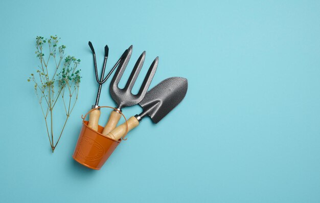 Garden tools for processing beds in the garden on a blue background Top view