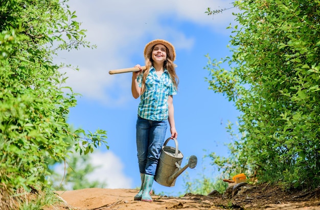 Garden tools shovel and watering can kid worker sunny outdoor family bonding spring country side village future success little girl on rancho summer farming farmer little girl I love my job