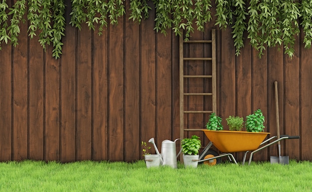 Photo garden with an old wooden fence and tools for gardening