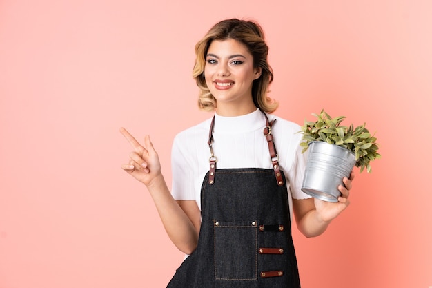 Gardener girl holding a plant