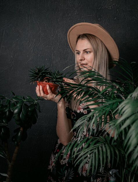 Gardener girl is engaged in her plants