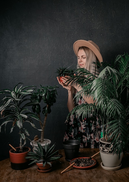 Gardener girl is engaged in her plants