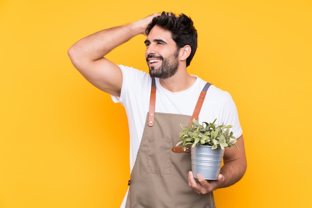 Gardener man over isolated yellow wall