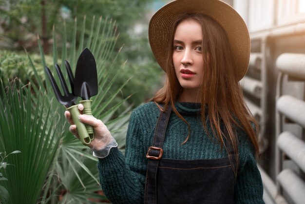 Photo gardener with garden tools in hands.