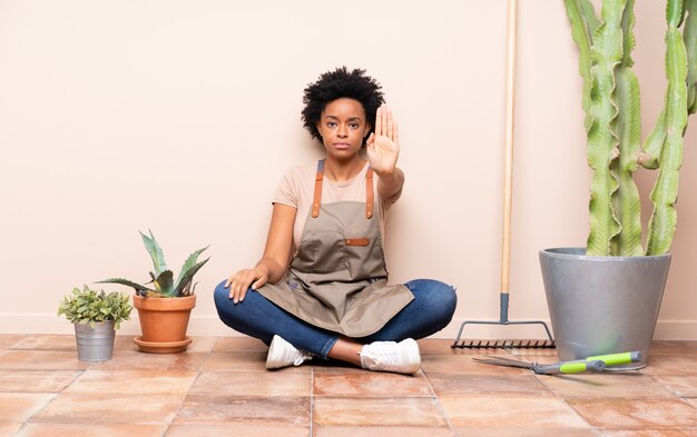 Gardener woman sitting on the floor