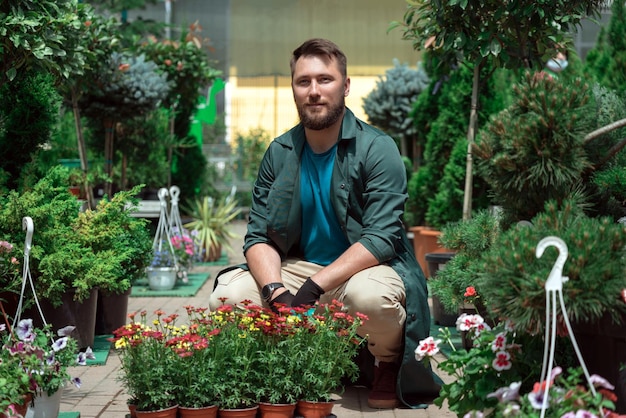 Gardeners working with flowers in garden center