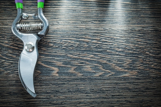 Gardening secateurs on wooden board